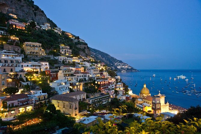 Hillside coastal town illuminated above the sea